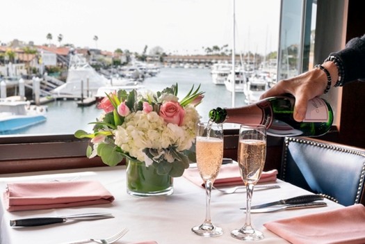 Table by the water with champagne pouring