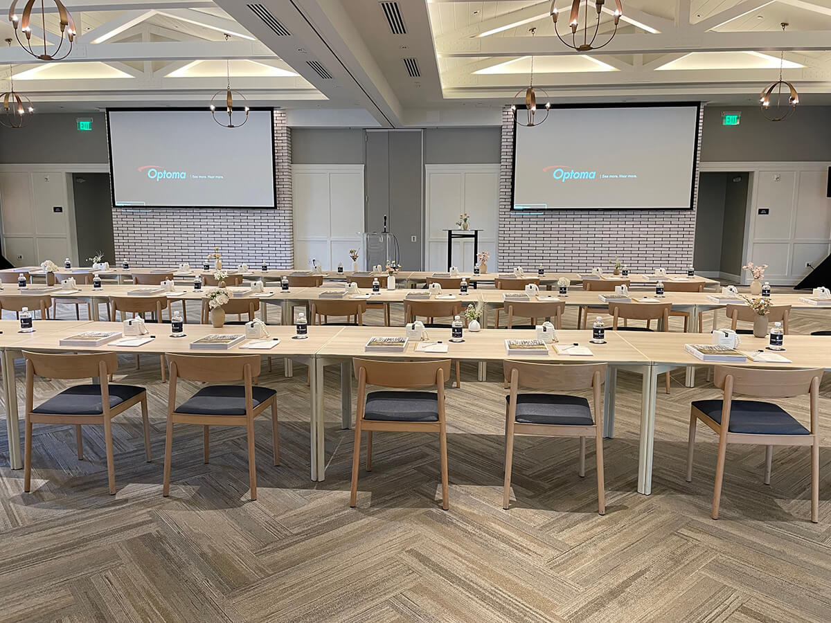 tables lined up with a projector on top