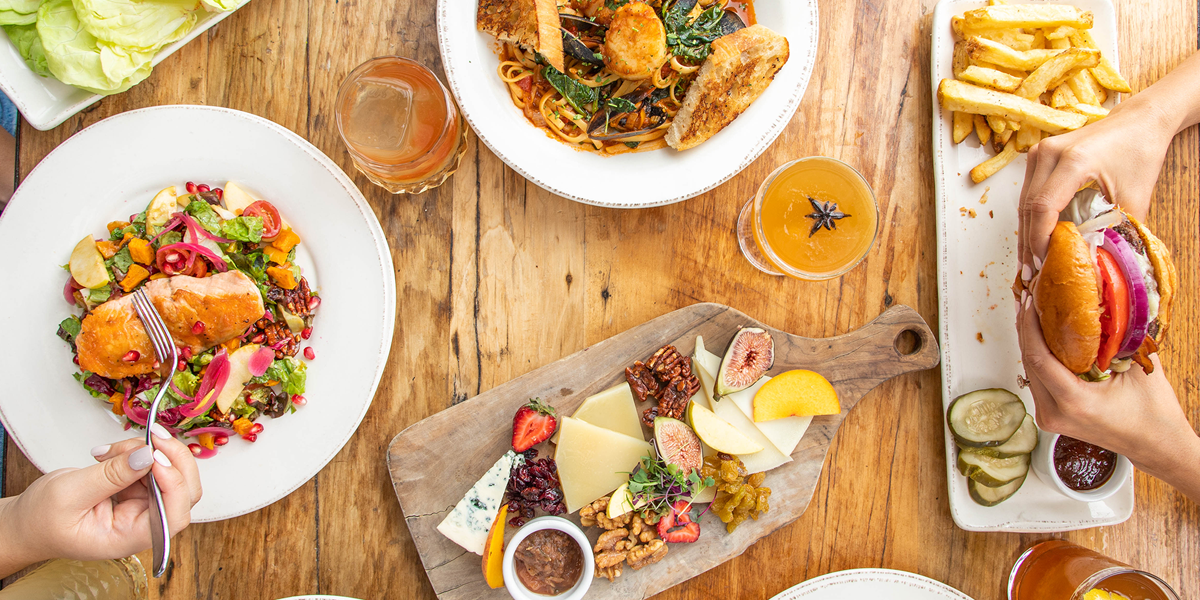 table with drinks and plates of food