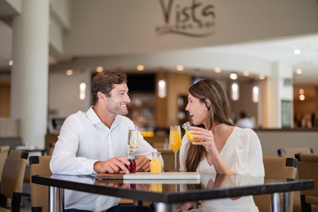 a man and woman having breakfast