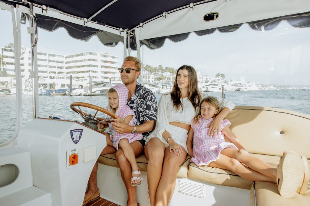 dad, mom, and 2 daughters on a duffy boat