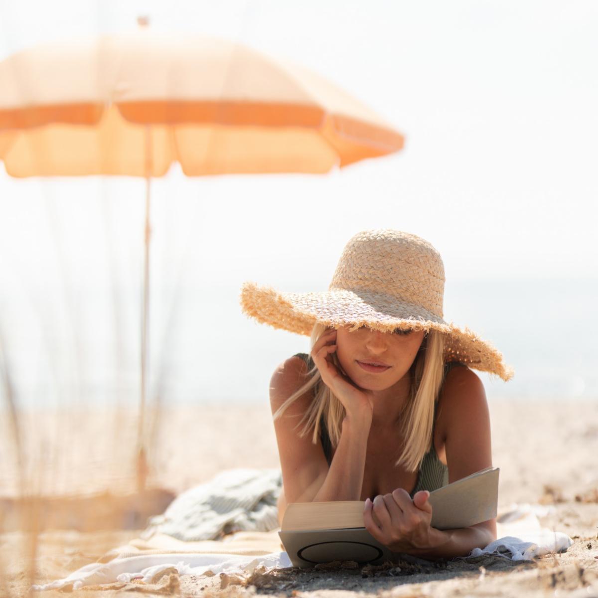 woman reading on beach