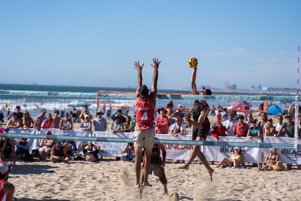 people playing volleyball on the beach