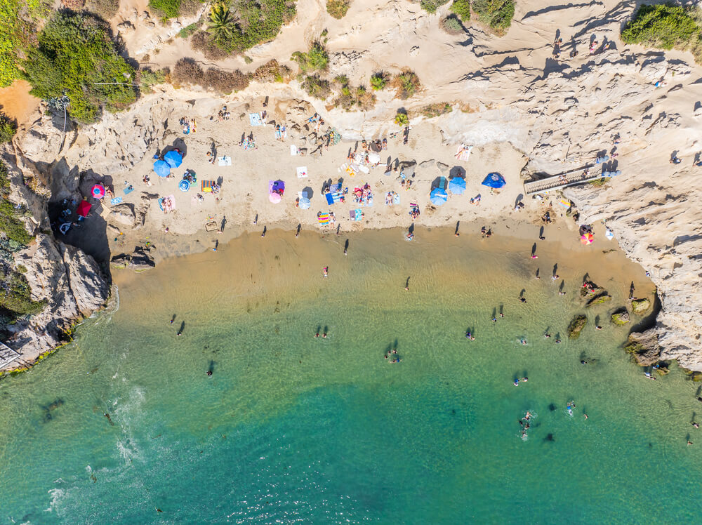 beach with people in the water and sand