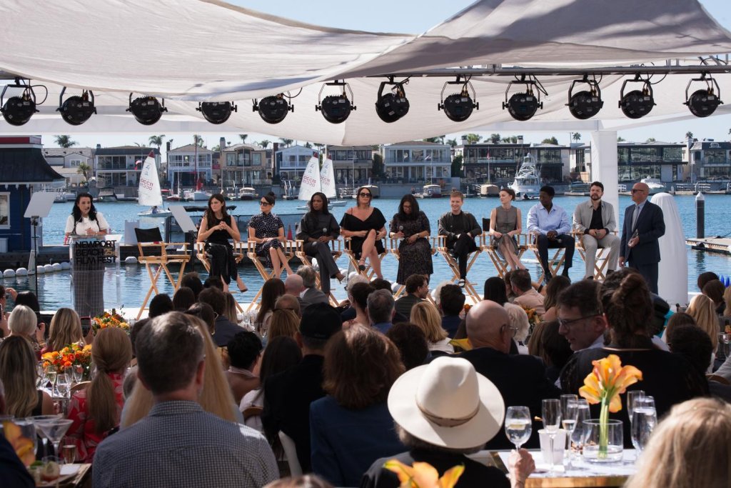 people sitting down with the bay as a backdrop