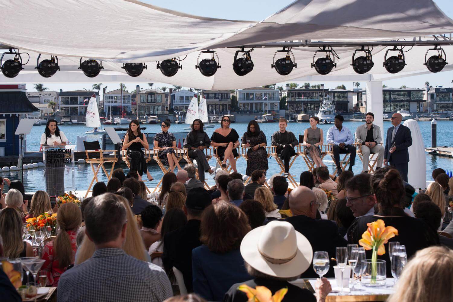people sitting down with the bay as a backdrop