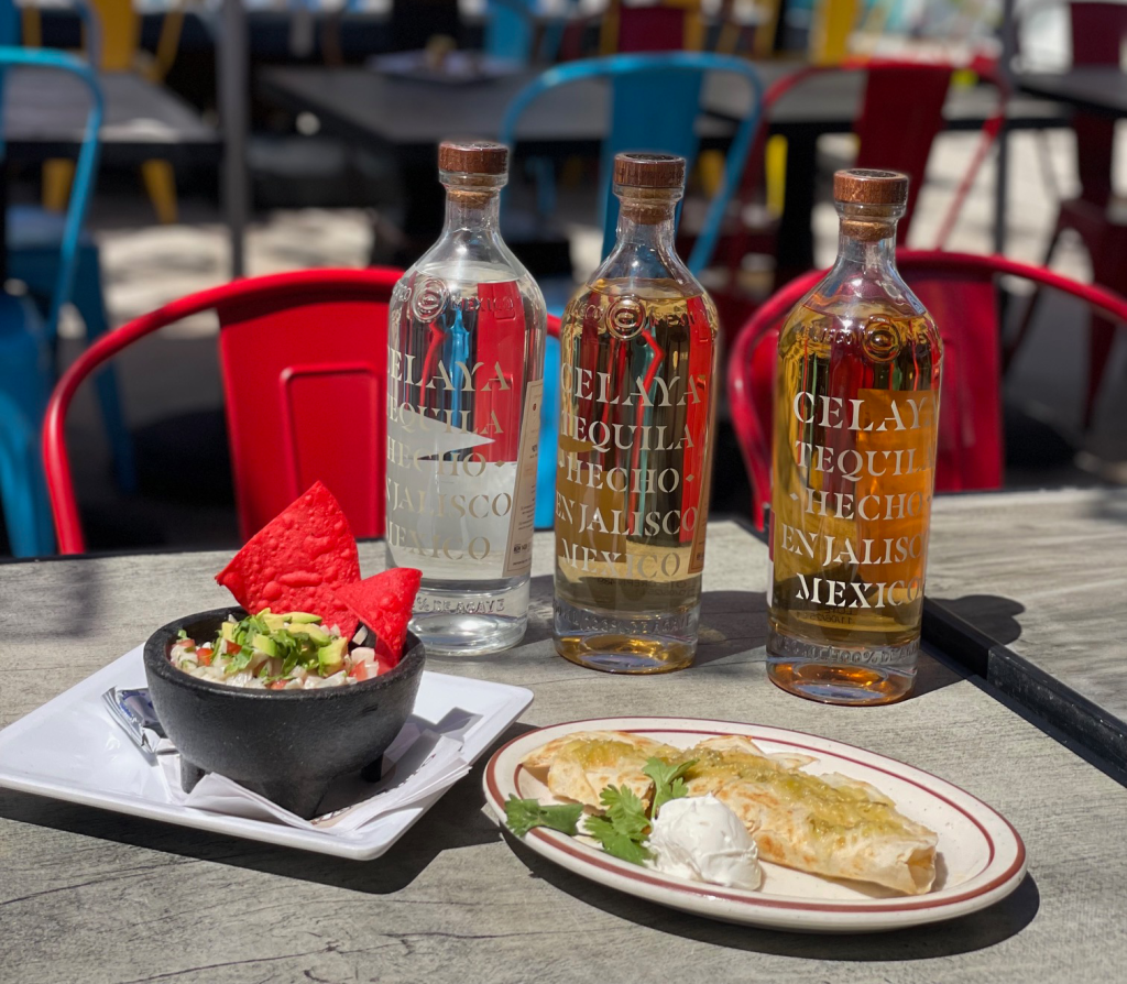 tequila bottles and mexican food on a plate
