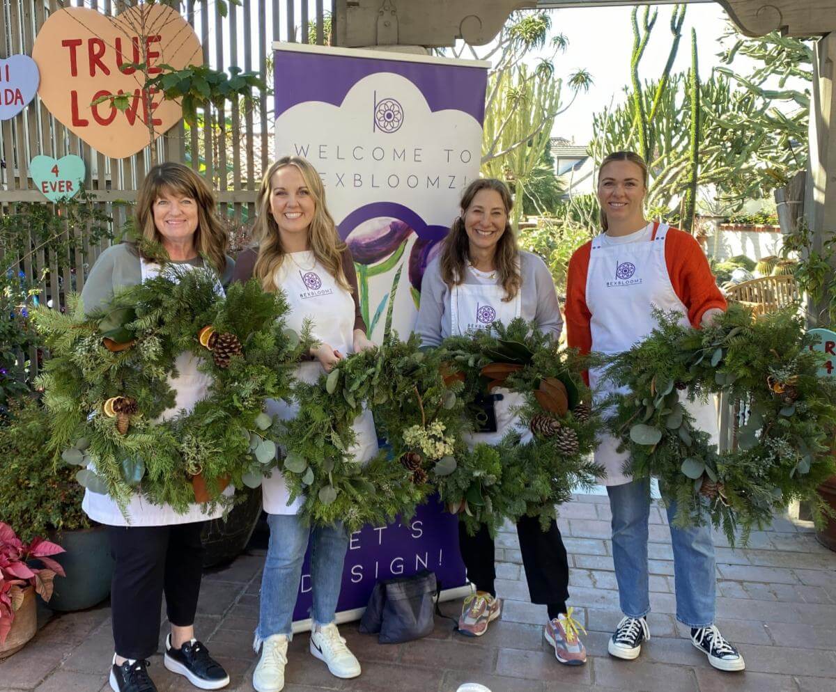 woman holding wreaths
