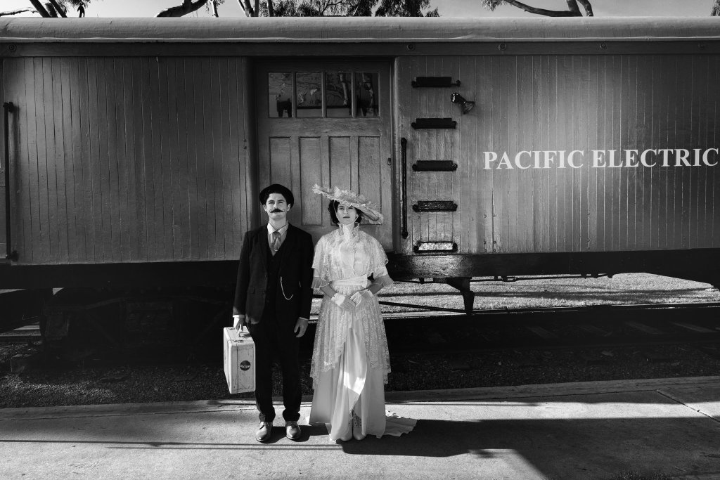 couple in front of a train