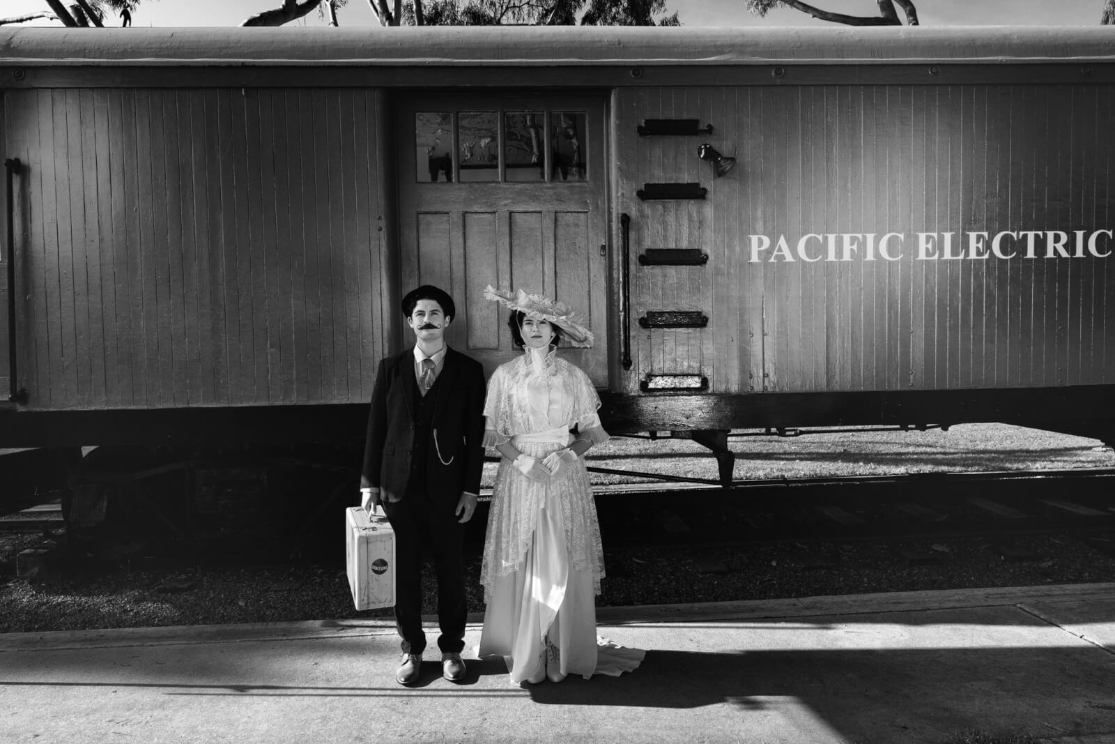 couple in front of a train
