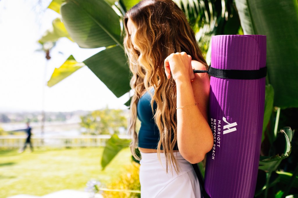Woman carrying yoga mat